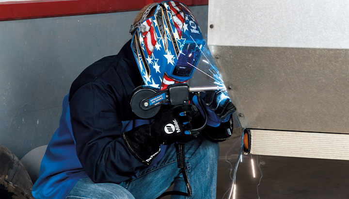 Welder using spool gun to weld aluminum trailer